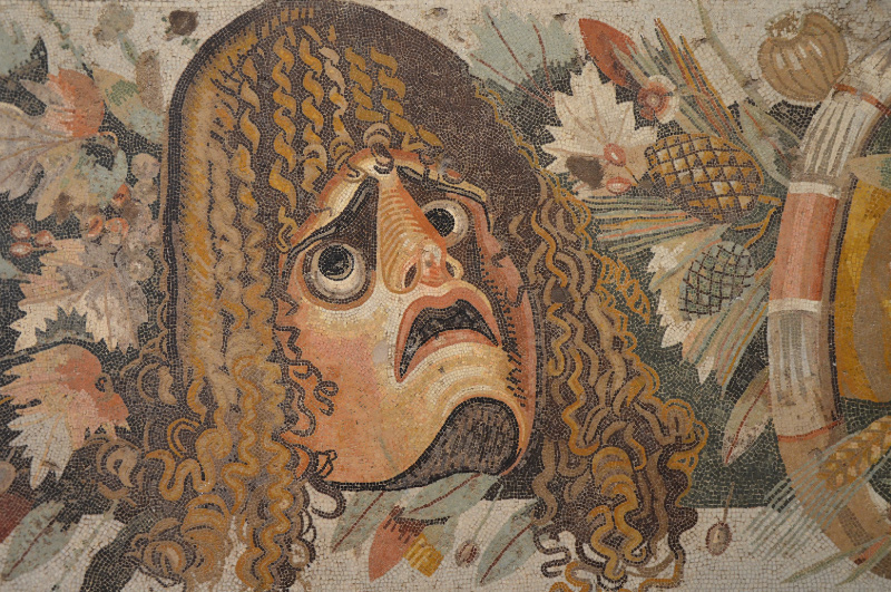 Mosaic depicting a tragic mask in the midst of fruits, flowers and garlands from the House of the Faun in Pompeii